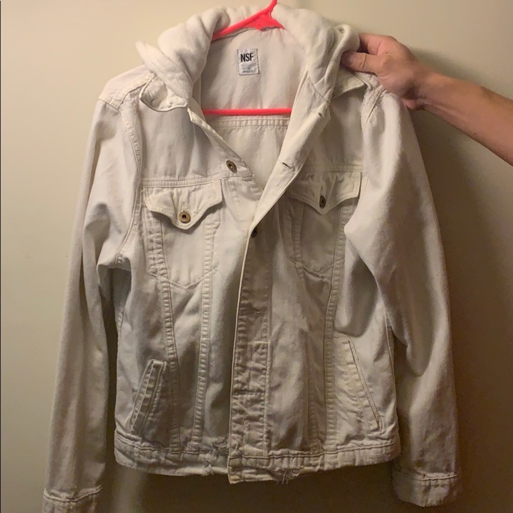 A distressed jean jacket with 100% cotton hood.